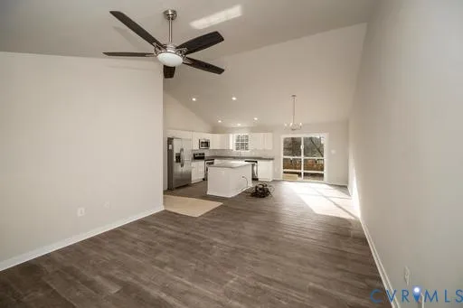 a view of a livingroom with a kitchen and a stove top oven
