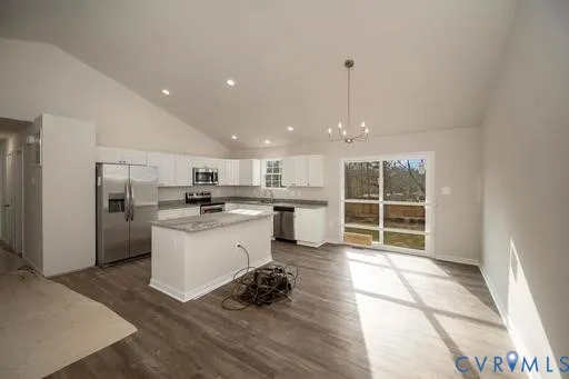 a kitchen with white cabinets and window