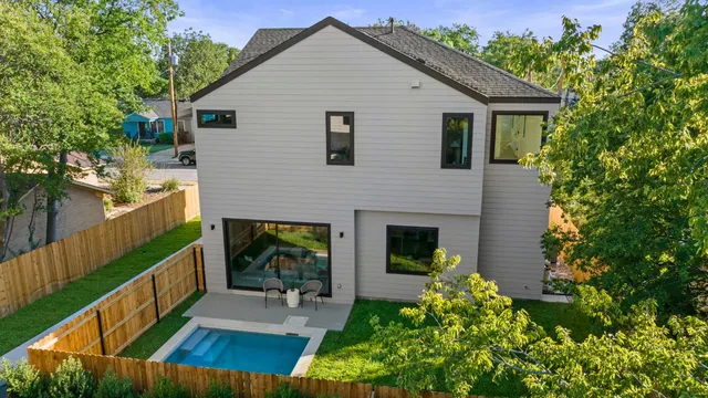 a view of house with backyard and outdoor seating