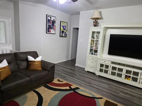a living room with furniture and a mirror