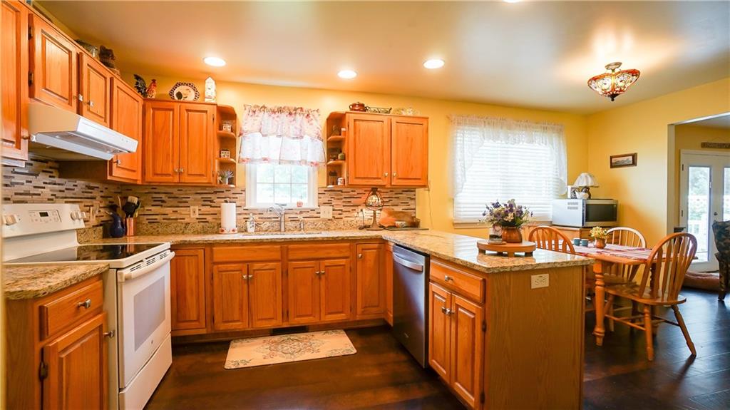 236 1/2 Meridian Road Butler, PA 16001 - Photo 4 of 24 a kitchen with stainless steel appliances granite countertop a sink a stove and a wooden floors