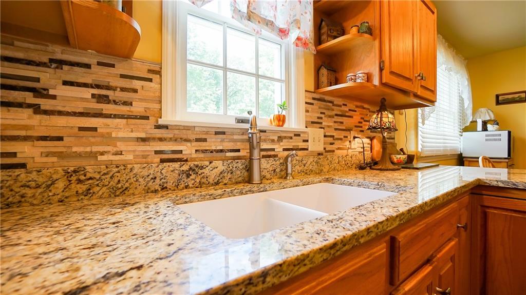 236 1/2 Meridian Road Butler, PA 16001 - Photo 8 of 24 a bathroom with a granite countertop sink and a large mirror