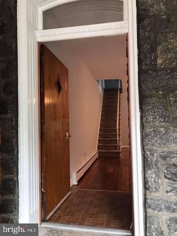 450 Seville Street Philadelphia, PA 19128 - Photo 3 of 14 a view of a hallway with wooden floor and stairs