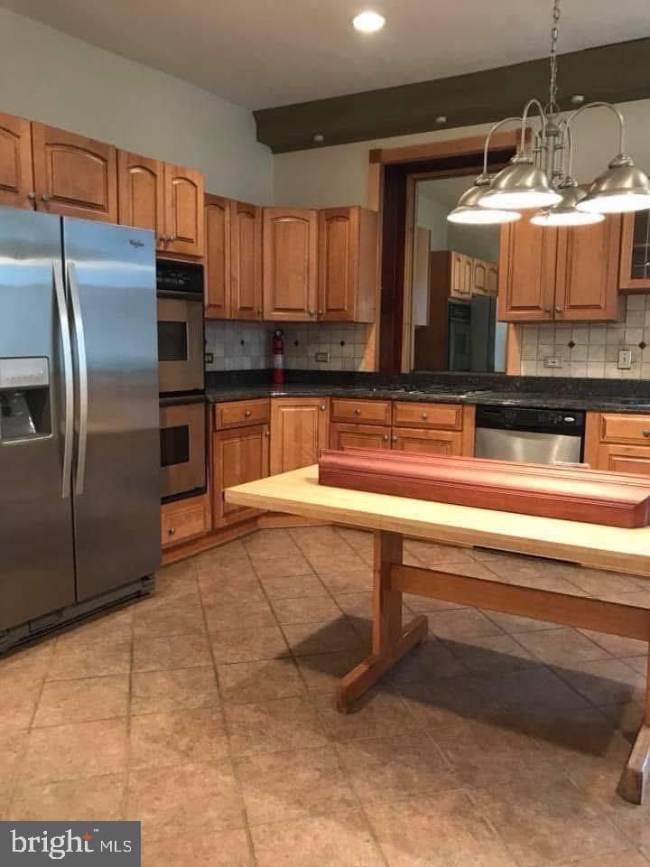 450 Seville Street Philadelphia, PA 19128 - Photo 6 of 14 a kitchen with granite countertop a stove and a sink