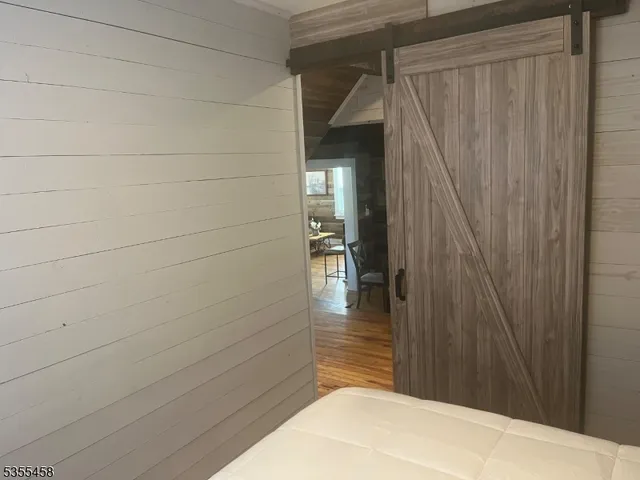 a bedroom with a bed and a potted plant on it