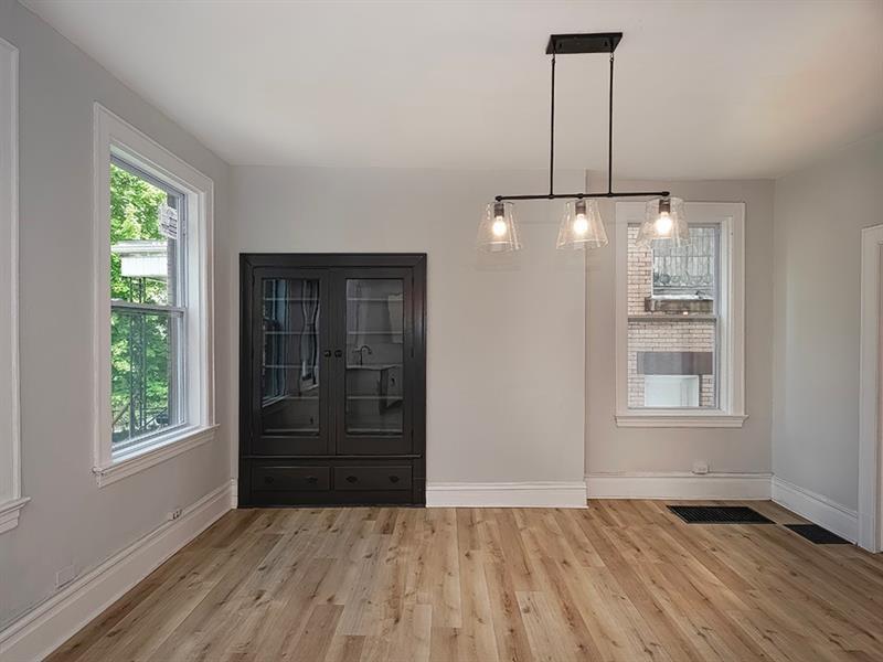 923 Adelaide Street Pittsburgh, PA 15219 - Photo 11 of 32 a view of an empty room with a window and wooden floor
