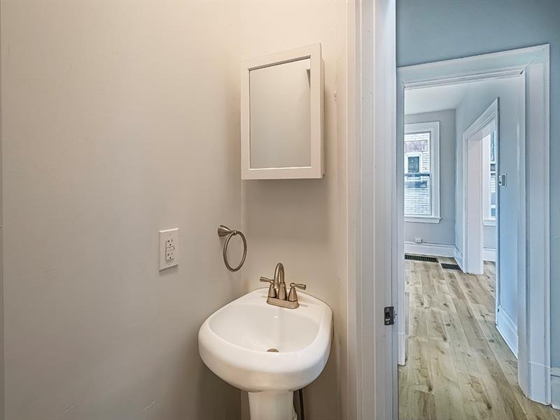 923 Adelaide Street Pittsburgh, PA 15219 - Photo 17 of 32 a bathroom with a sink and a mirror