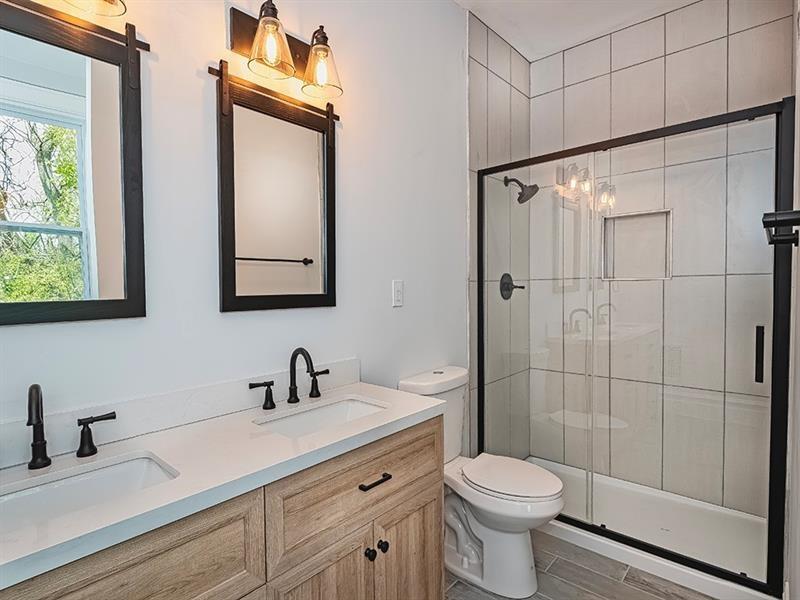 923 Adelaide Street Pittsburgh, PA 15219 - Photo 21 of 32 a bathroom with a toilet sink shower and mirror