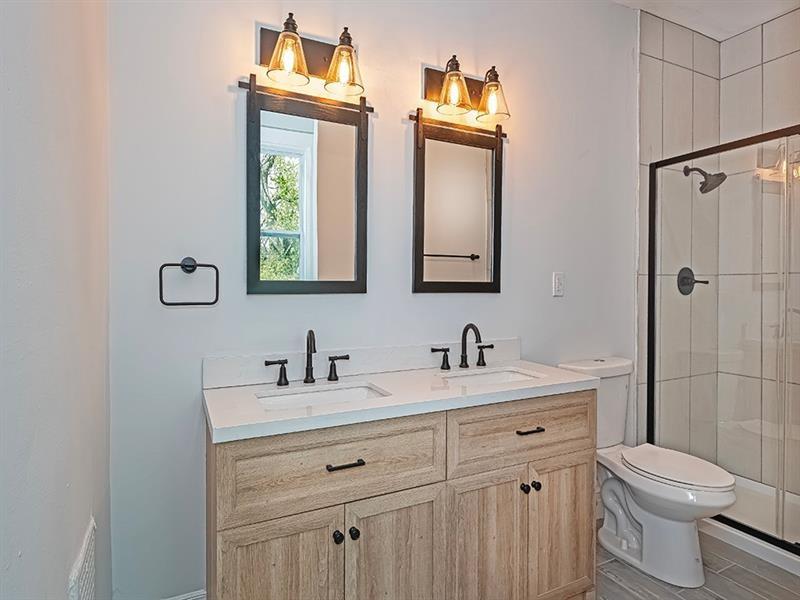 923 Adelaide Street Pittsburgh, PA 15219 - Photo 22 of 32 a bathroom with a toilet sink and mirror