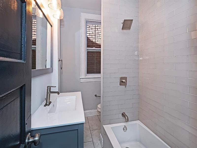 923 Adelaide Street Pittsburgh, PA 15219 - Photo 26 of 32 a bathroom with a sink a toilet and shower