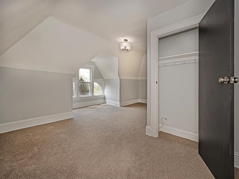 923 Adelaide Street Pittsburgh, PA 15219 - Photo 29 of 32 an empty room with a cabinet and mirrors
