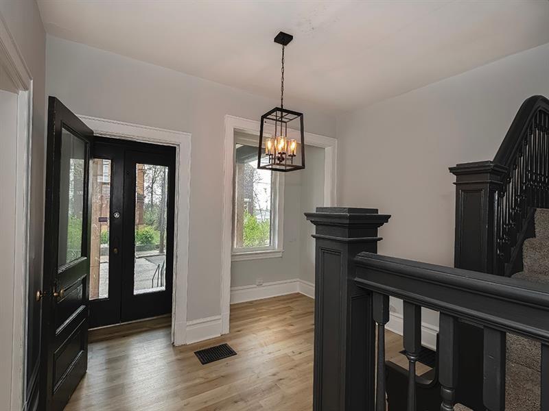 923 Adelaide Street Pittsburgh, PA 15219 - Photo 6 of 32 a view of hallway with wooden floor and windows