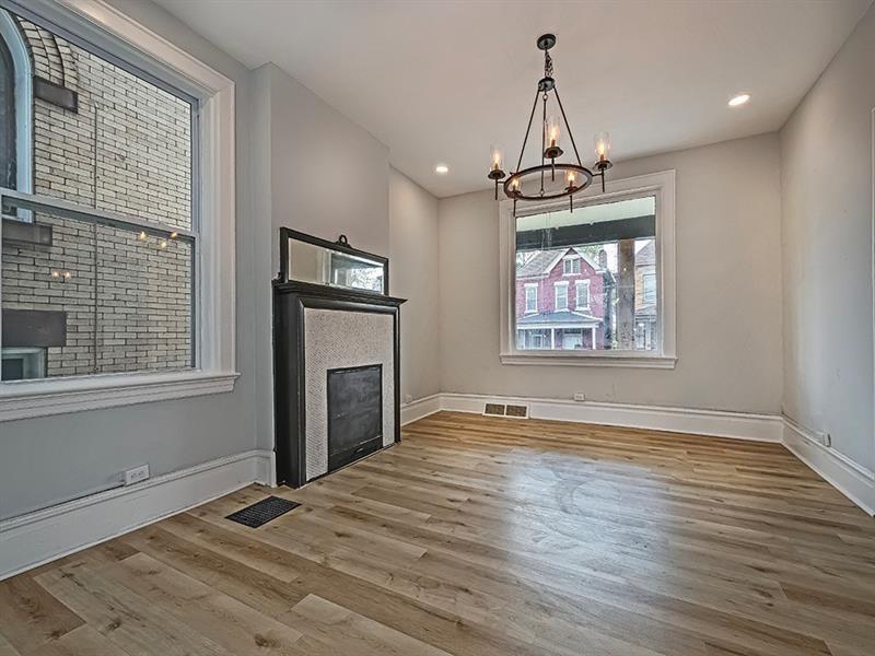 923 Adelaide Street Pittsburgh, PA 15219 - Photo 7 of 32 a view of an empty room with a window and wooden floor