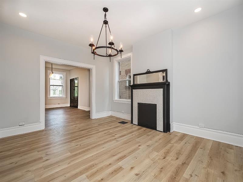 923 Adelaide Street Pittsburgh, PA 15219 - Photo 8 of 32 a view of empty room with wooden floor and fireplace