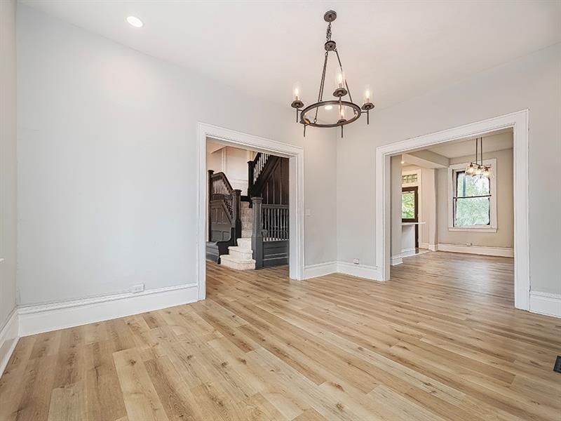 923 Adelaide Street Pittsburgh, PA 15219 - Photo 9 of 32 a view of empty room with wooden floor and chandelier