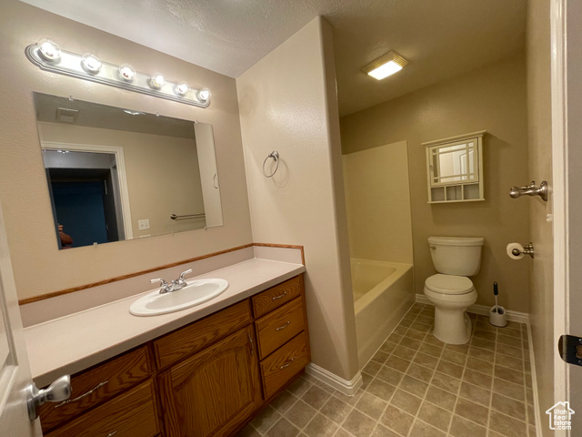 11473 South Dempsey Creek Road Lava Hot Springs, ID 83246 - Photo 27 of 47 Full bath featuring tile patterned floors, vanity, and a textured ceiling
