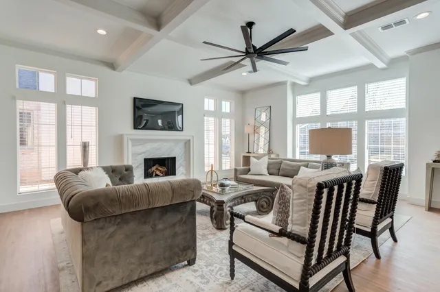 a dining room with furniture a chandelier and wooden floor