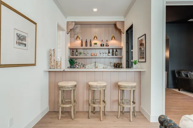 a kitchen with a stove a sink a center island and a wooden floor