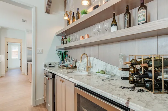 a kitchen with stainless steel appliances granite countertop a sink a stove a refrigerator and island