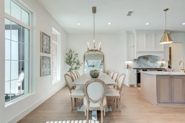 a kitchen with white cabinets and sink