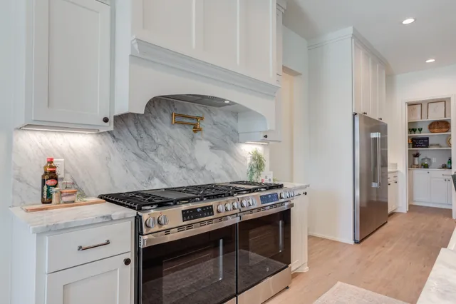 a bedroom with a bed and a flat tv screen on dresser
