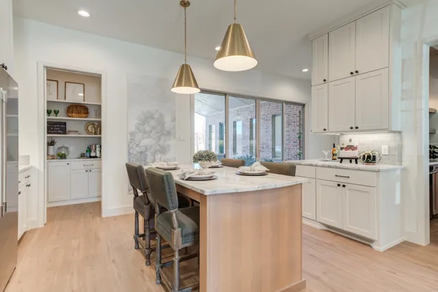 a kitchen with granite countertop a sink stove and cabinets
