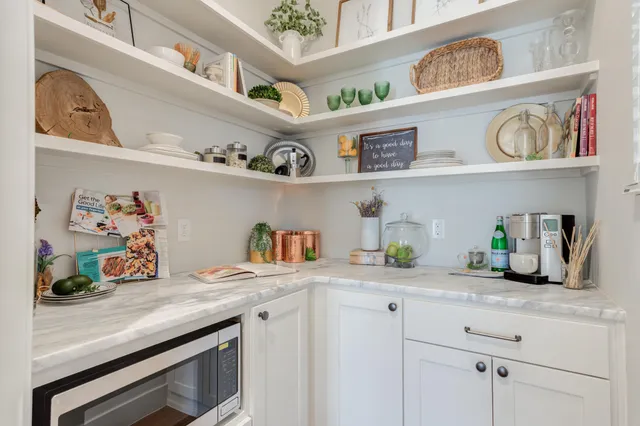 a bathroom with a granite countertop sink a toilet and shower