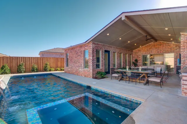 a living room with furniture a large window and a chandelier