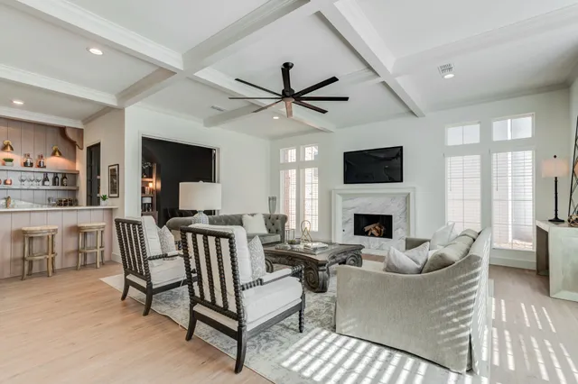a living room with furniture a fireplace and a table