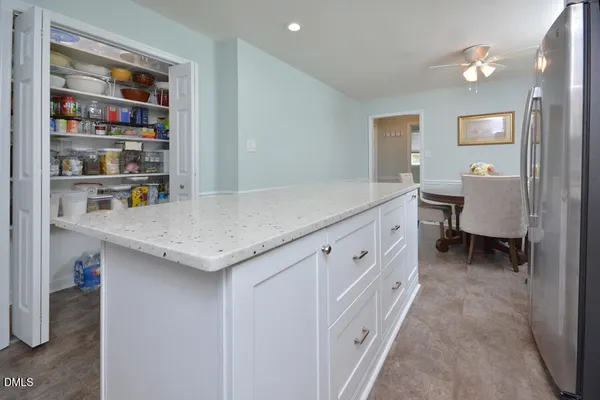 a kitchen with granite countertop a sink a stove and cabinets