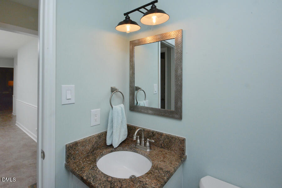 313 Andover Road Durham, NC 27712 - Photo 16 of 36 a bathroom with a granite countertop sink and a mirror