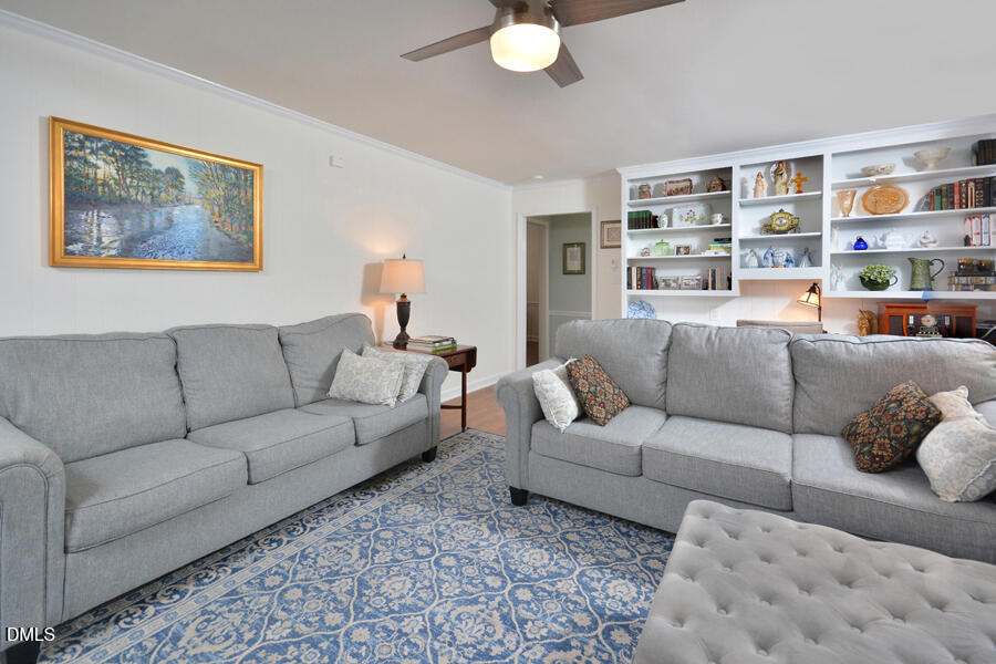 313 Andover Road Durham, NC 27712 - Photo 17 of 36 a living room with furniture and a book shelf