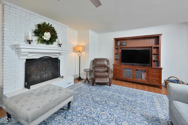 a bedroom with a bed and a potted plant on the dresser