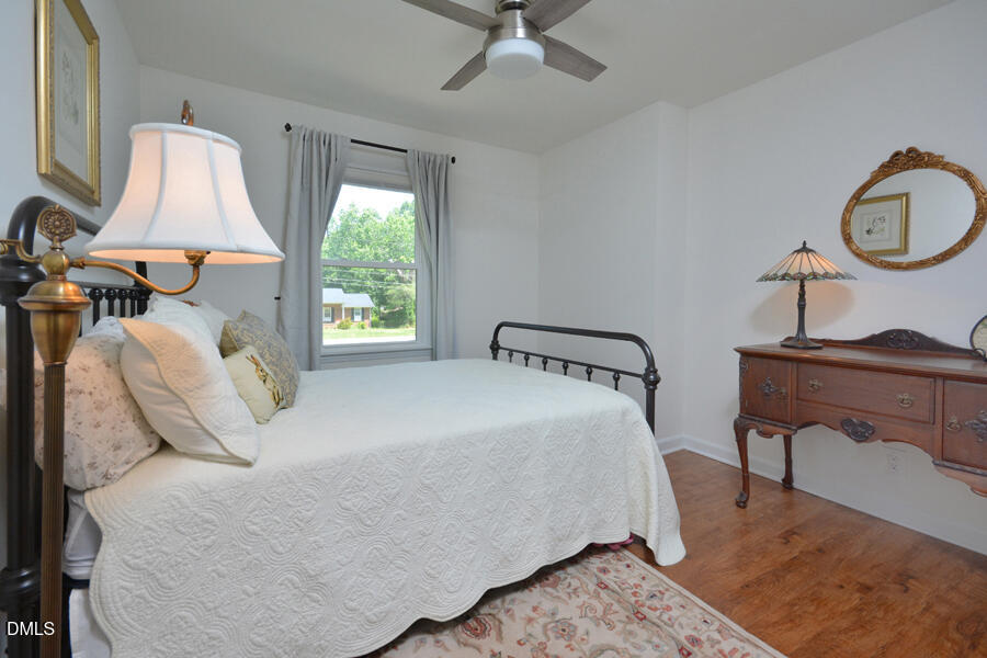 313 Andover Road Durham, NC 27712 - Photo 20 of 36 a bedroom with a bed and a potted plant on the dresser