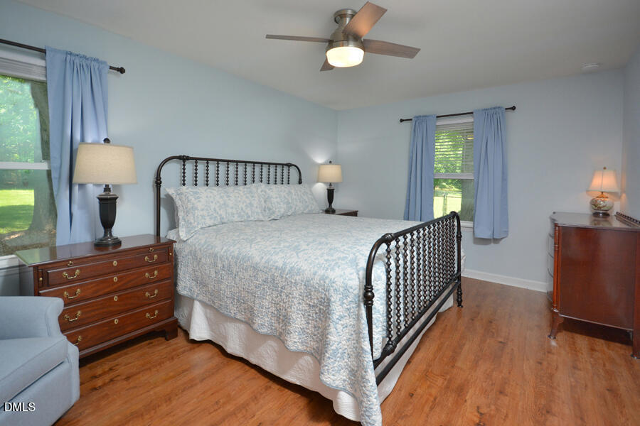 313 Andover Road Durham, NC 27712 - Photo 26 of 36 a bedroom with a bed and a chandelier