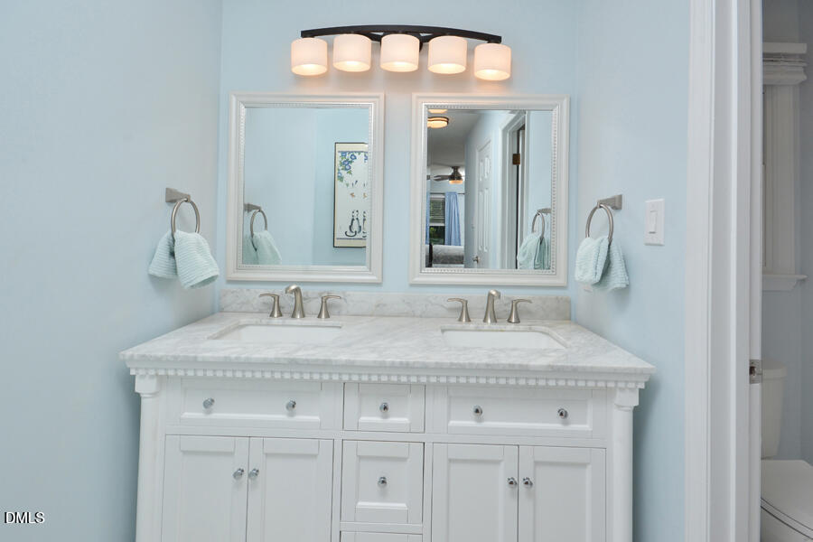 313 Andover Road Durham, NC 27712 - Photo 28 of 36 a bathroom with a sink vanity and a mirror