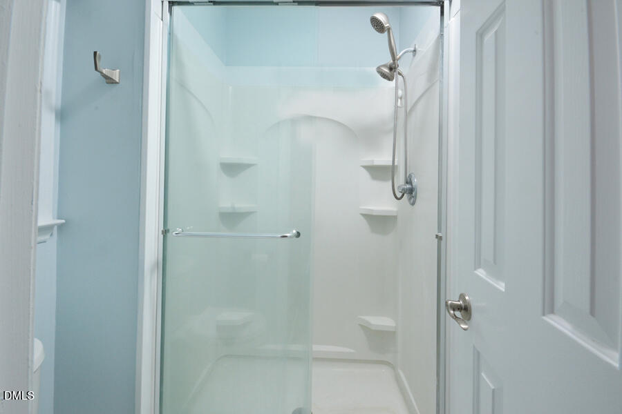 313 Andover Road Durham, NC 27712 - Photo 29 of 36 a bathroom with a glass shower door