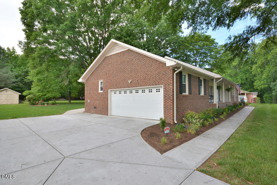 313 Andover Road Durham, NC 27712 - Photo 31 of 36 a front view of a house with garden