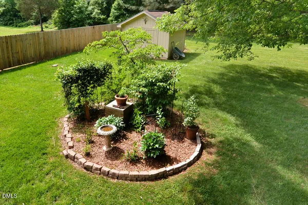 a view of backyard of house with green space