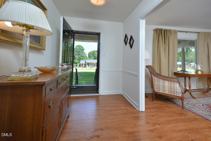 313 Andover Road Durham, NC 27712 - Photo 3 of 36 a kitchen with granite countertop a stove a refrigerator and a dining table