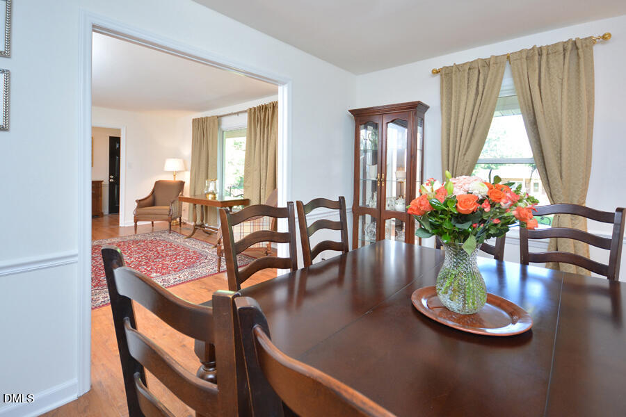 313 Andover Road Durham, NC 27712 - Photo 7 of 36 a dining room with furniture and a potted plant