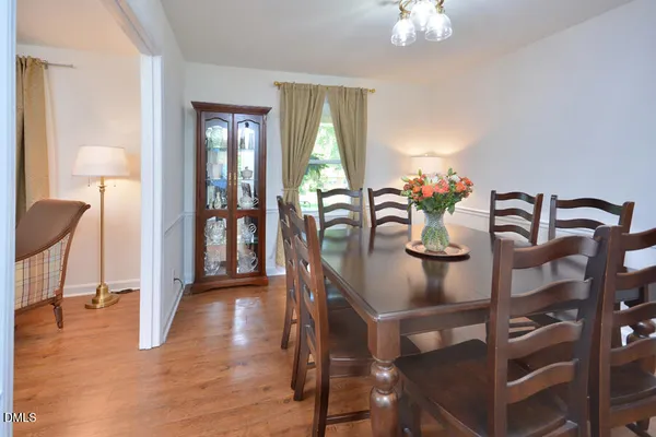 a view of a dining room with furniture and chandelier