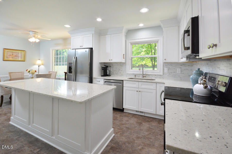 313 Andover Road Durham, NC 27712 - Photo 9 of 36 a kitchen with stainless steel appliances a sink stove and refrigerator