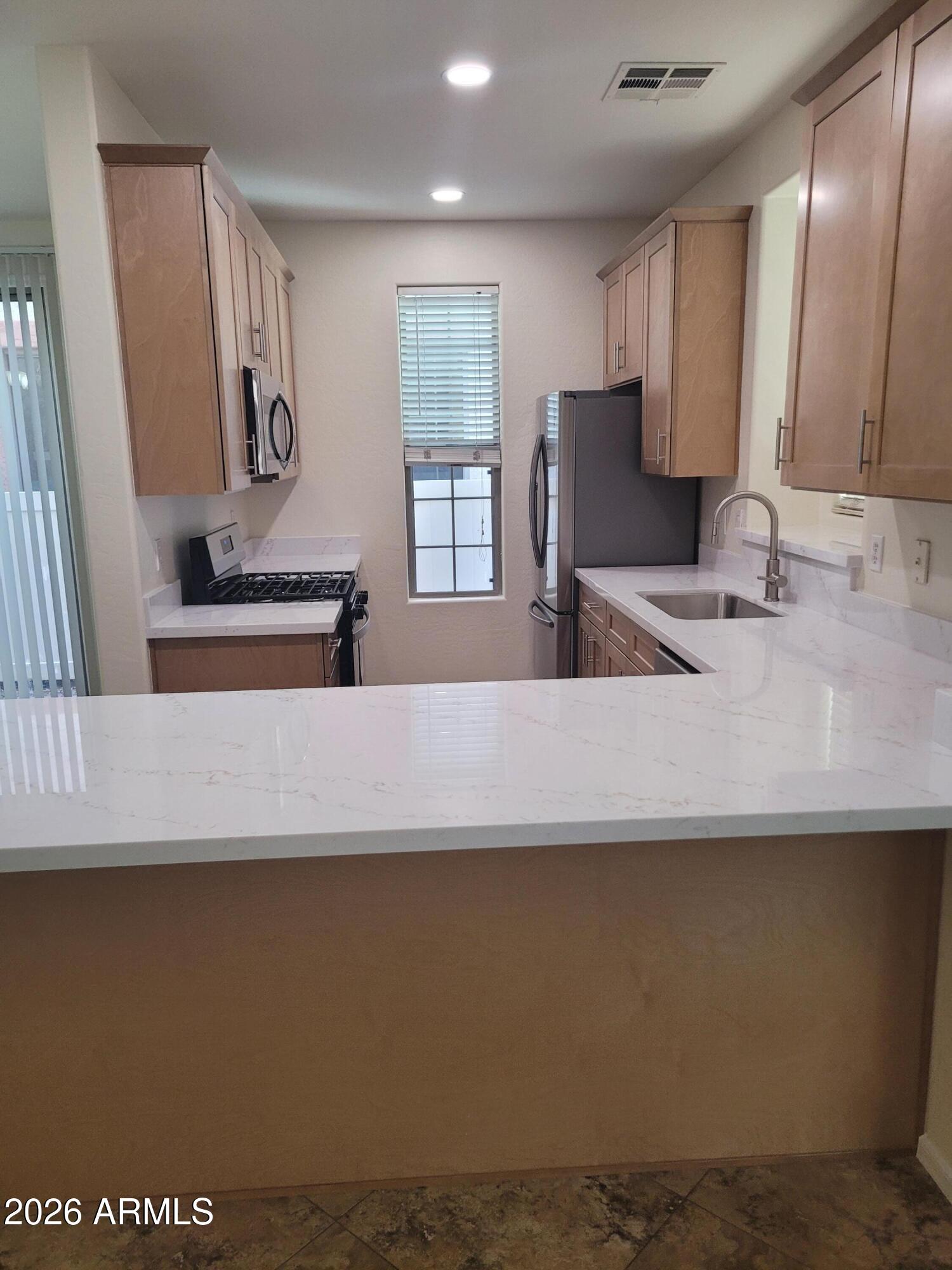 1453 South Sinova Avenue Gilbert, AZ 85296 - Photo 8 of 46 a view of kitchen with sink and refrigerator