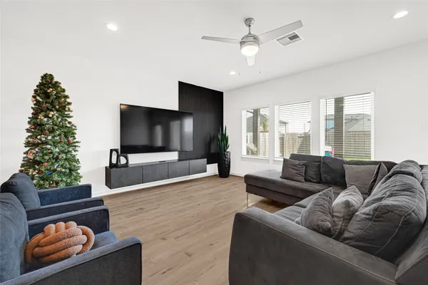 a living room with furniture and a potted plant