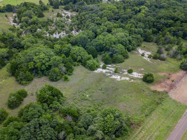 an aerial view of a forest with houses