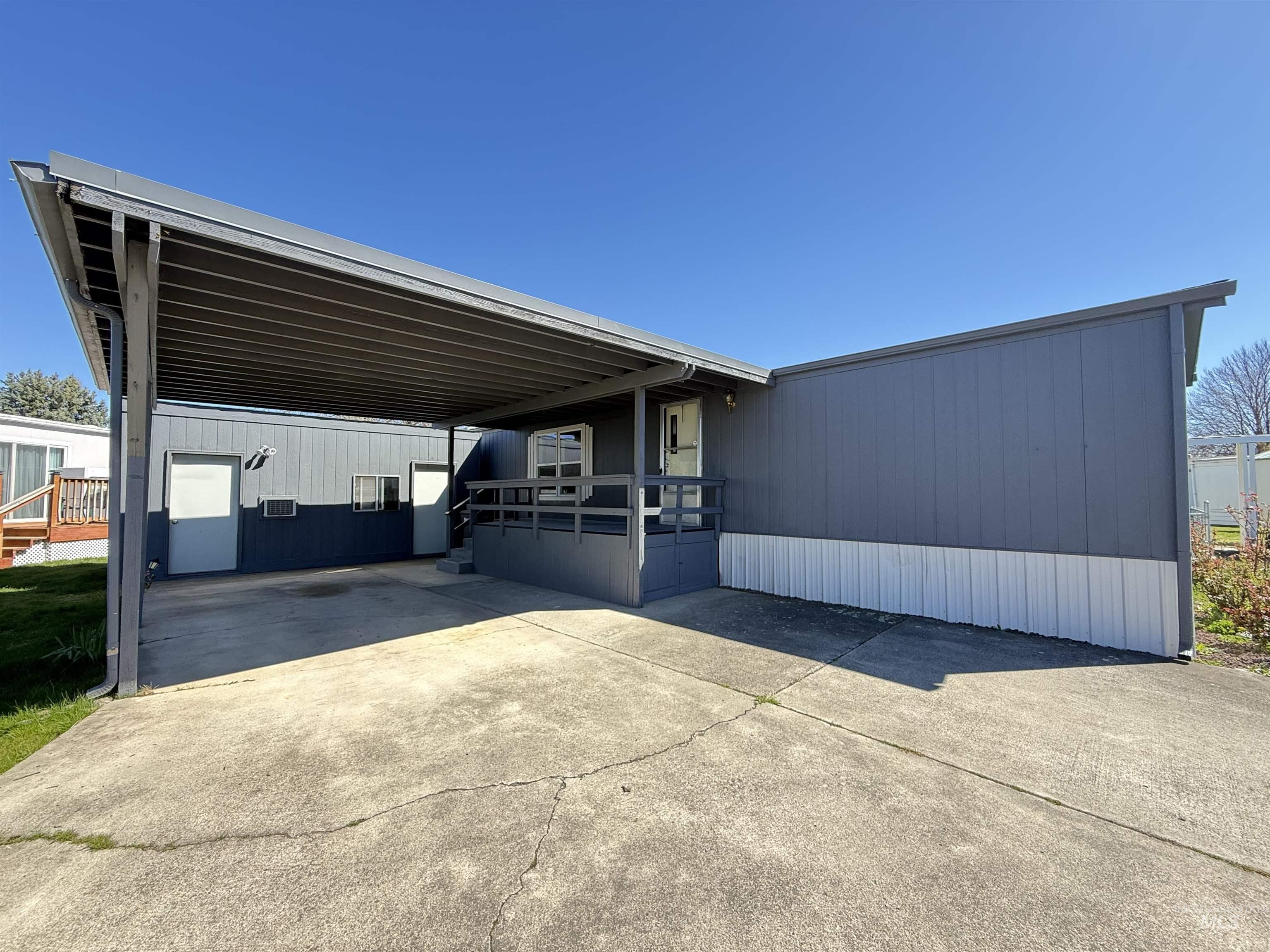 2015 6th Avenue, Unit 321 Clarkston, WA 99403 - Photo 33 of 34 View of front facade with a wooden deck, concrete driveway, and a carport