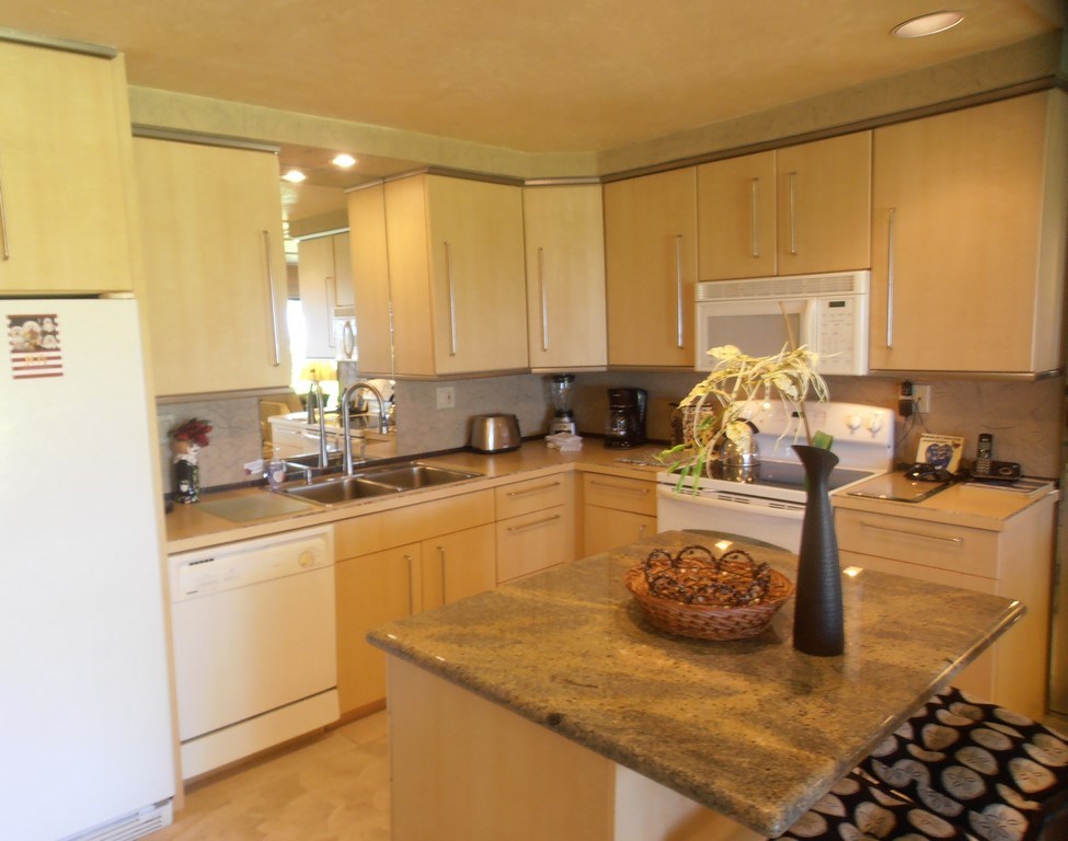 12 South Kihei Road, Unit G5 Kihei, HI 96753 - Photo 11 of 28 a kitchen with a sink a stove and cabinets