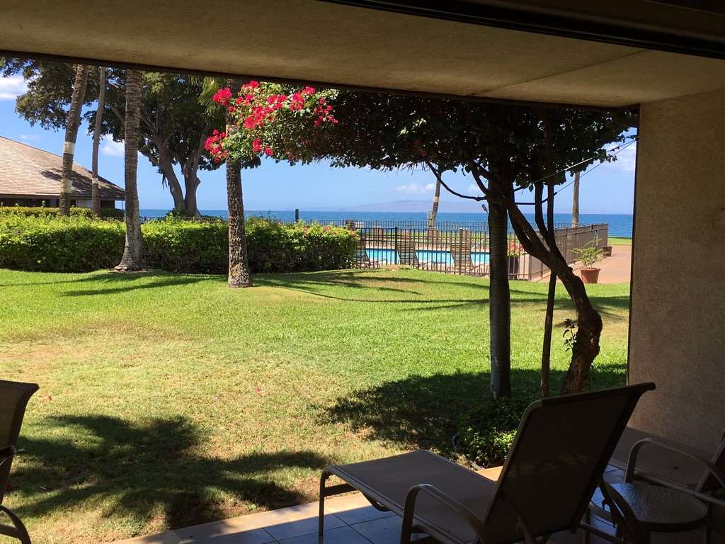 12 South Kihei Road, Unit G5 Kihei, HI 96753 - Photo 27 of 28 a view of a swimming pool with an outdoor seating and a yard