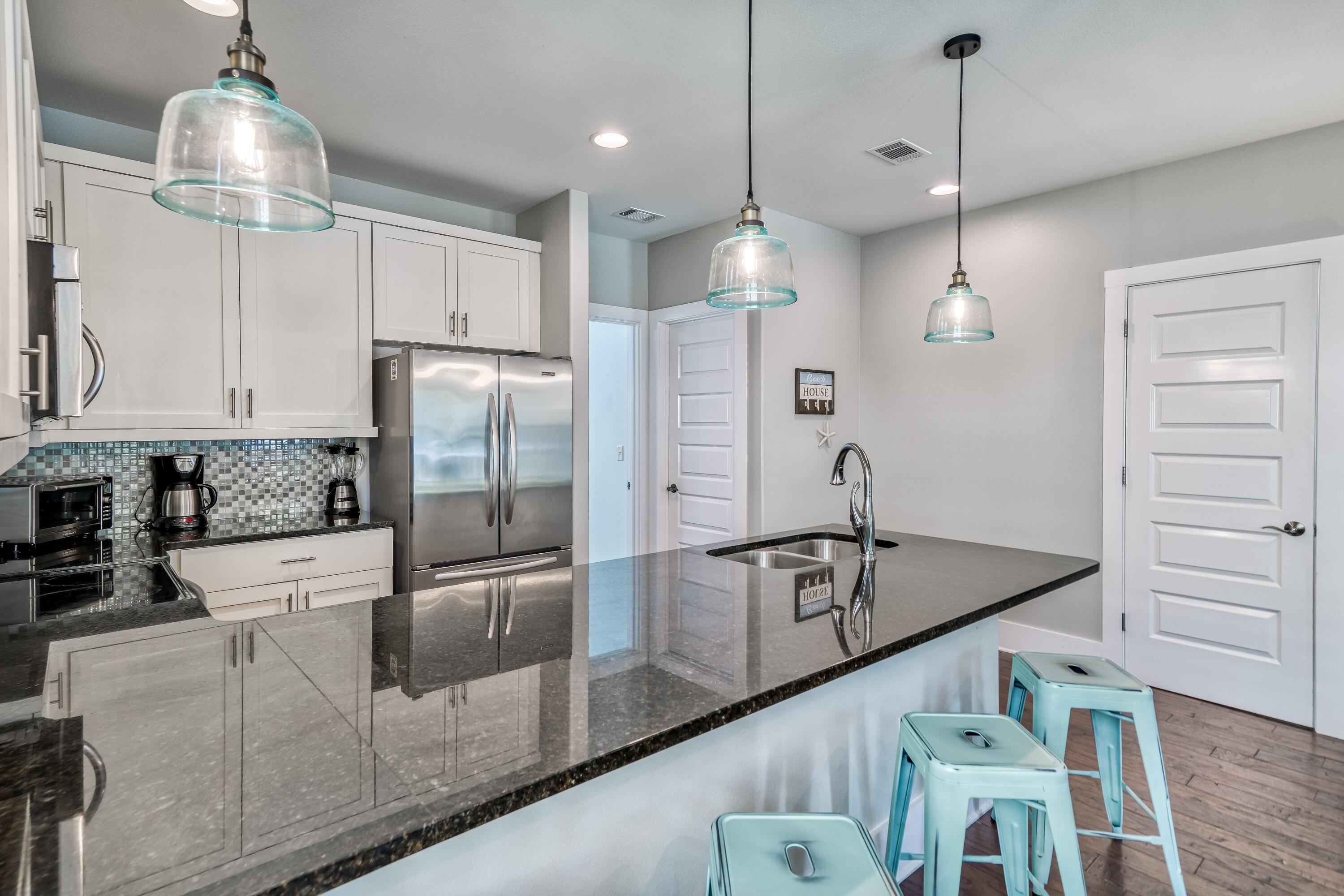 15 Asher Way Santa Rosa Beach, FL 32459 - Photo 14 of 57 a kitchen with stainless steel appliances granite countertop a refrigerator a sink and wooden floors